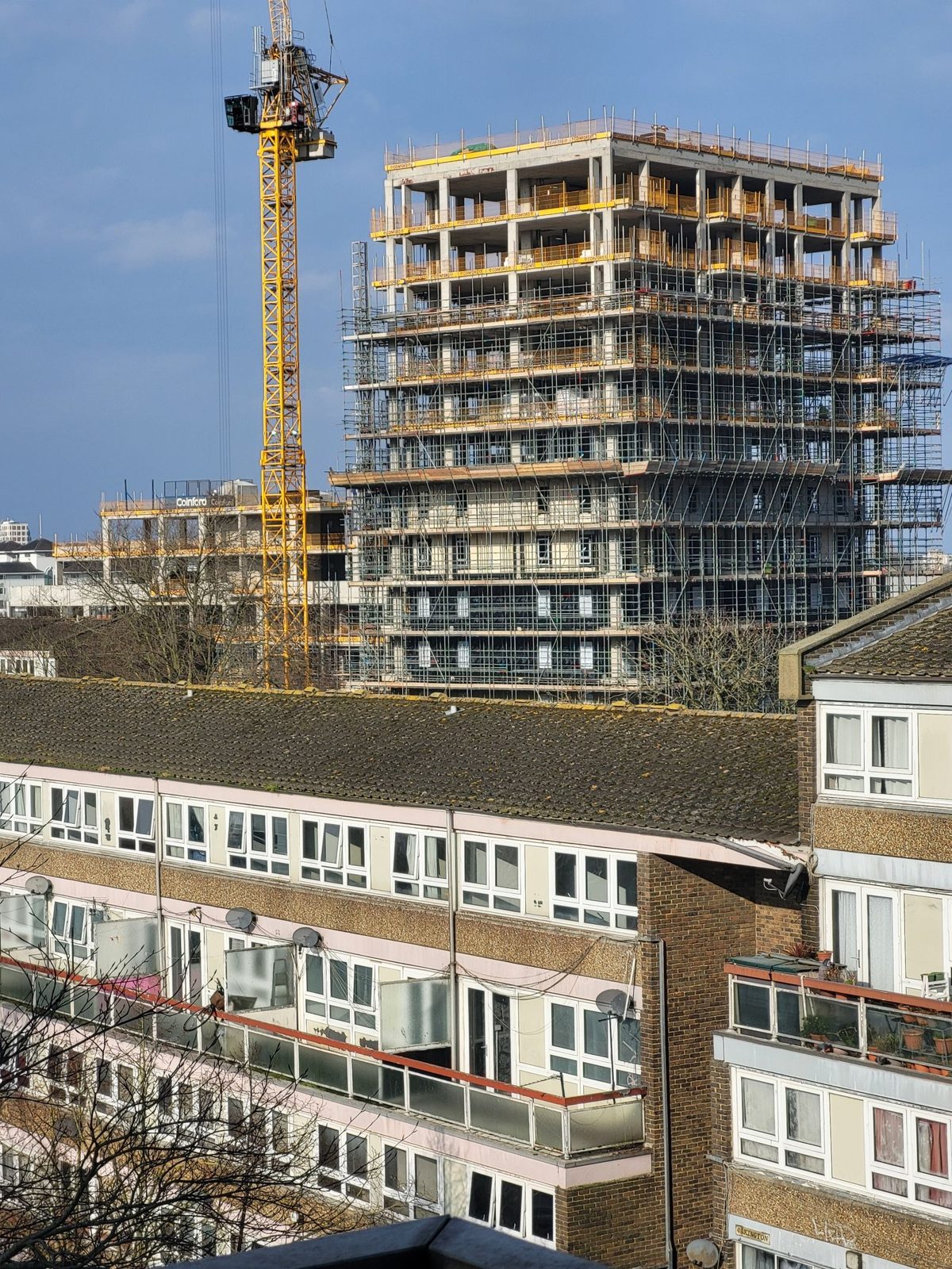 High-rise building under construction with a tower crane